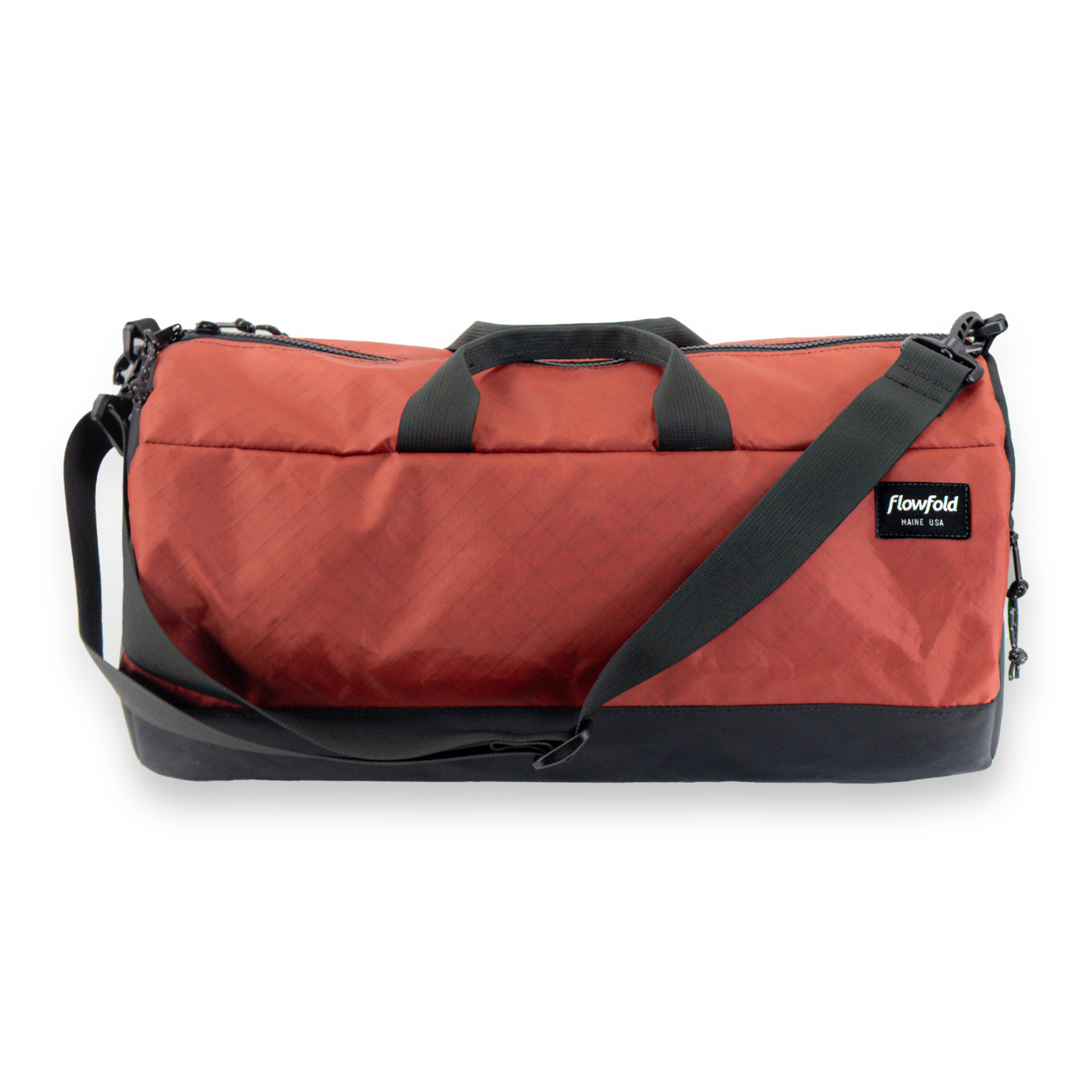 Red duffel bag with black straps on a white background