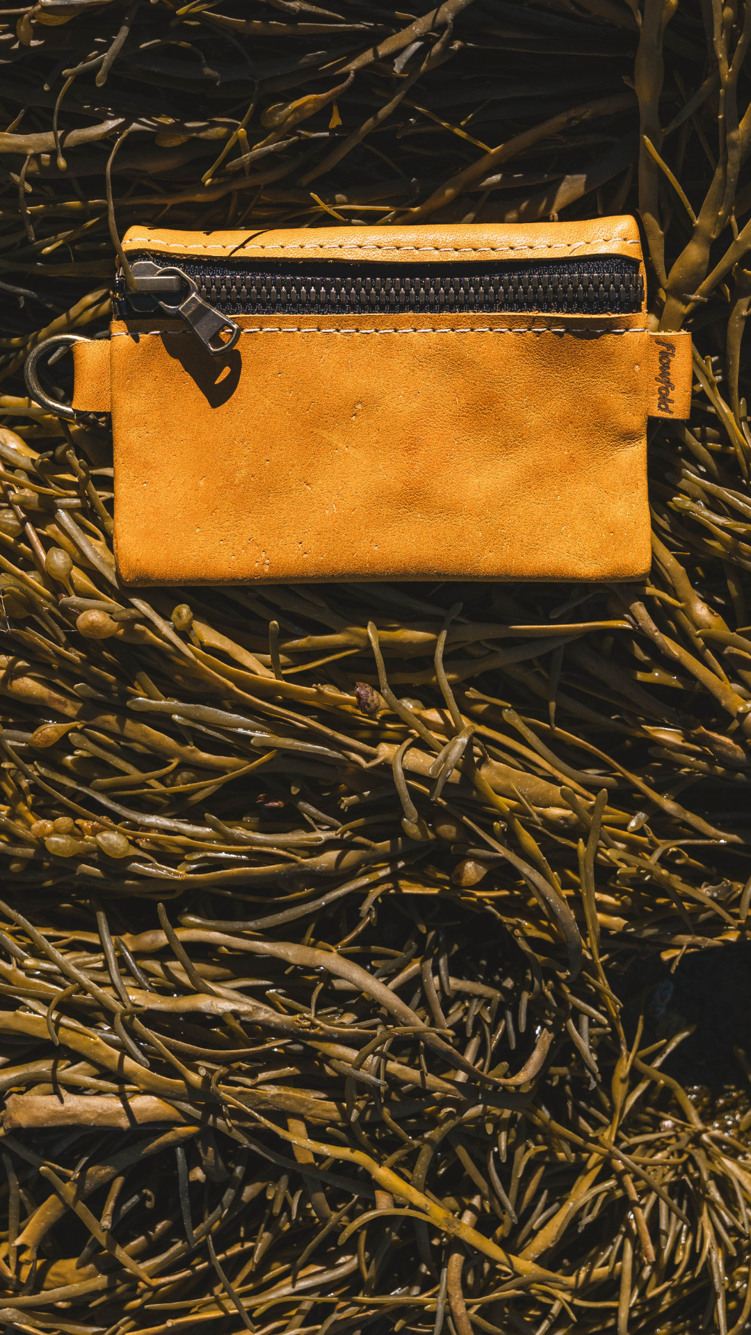 Citron leather pouch on a seaweed background